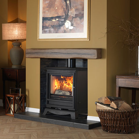 multi fuel stove with wooden beam